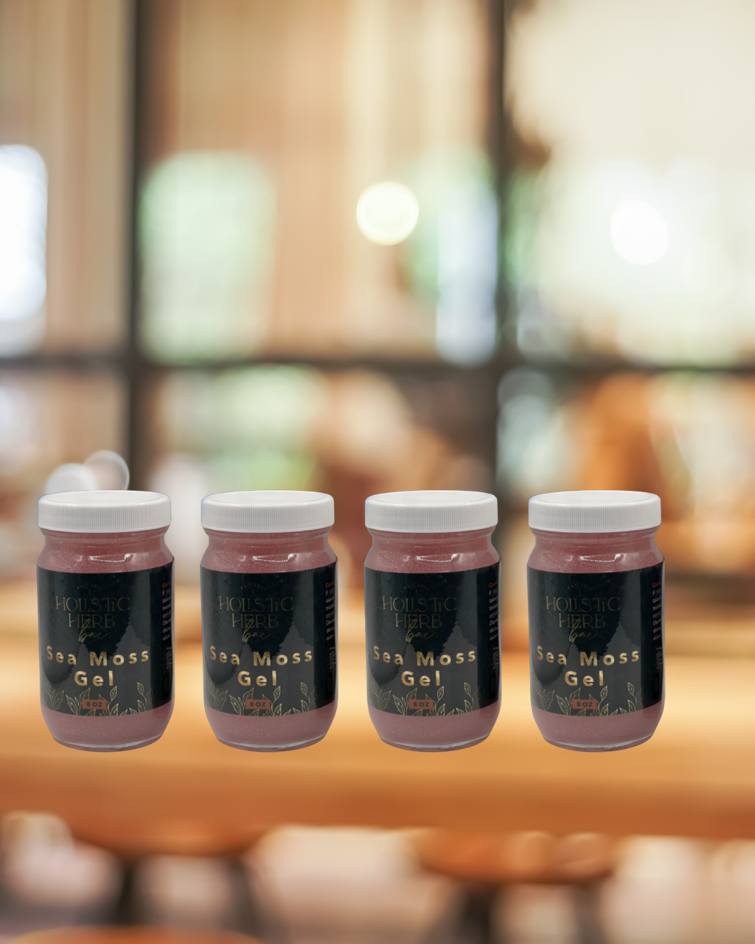 Four jars of Sea Moss Gel on a wooden surface with a blurred background